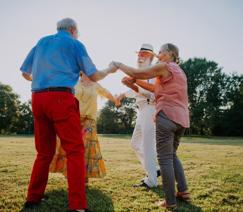 Group of youthful seniors having fun outdoors - Four pensioners bonding outdoors, concepts about lifestyle and elderly